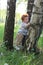 Little boy trying to walk by trees