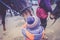 A little boy in turquoise overalls stroking an Icelandic pony horse with a funny forelock. The kid thanks the horse after