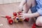 The little boy twists the bolt into a wooden machine