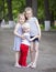 Little boy and two older cousins, meeting in the summer park