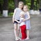 Little boy and two older cousins, meeting in the summer park