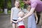 Little boy and two older cousins, meeting in the summer park