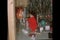 Little boy unwrapping presents under Christmas tree