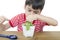 Little boy using magnifier watching new plant