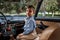 Little boy in vintage clothes sitting in retro car