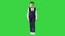 Little boy in a waistcoat and a bow tie walking looking straight ahead on a Green Screen, Chroma Key.