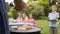 Little boy waiting for barbecue cooked by father