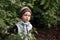 A little boy on a walk. Green foliage. Beautiful child