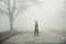 Little boy walking through the fog in forest : Soft focus