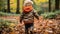 a little boy walking through a forest in the fall