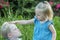 Little boy wants to kiss sister. Children play and fool around in nature