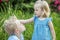 Little boy wants to kiss sister. Children play and fool around in nature