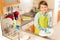 Little boy wash dished in sink with mop and soap