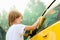 Little boy washing car.