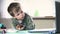 Little boy watching cartoons on laptop, stock footage