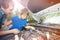 Little boy watching his father work on car engine