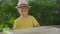 Little boy waters the plants in pots in his home garden on a balcony. Home farming concept