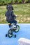 Little boy wearing a bicycle helmet rides a bicycle on a playground for children
