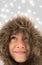 Little boy wearing fur coat protect from cold snow over head