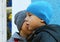 Little boy whispers a secret to his friend wearing winter hats