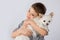 Little boy white Chihuahua dog on white background. Kids pet friendship