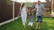 Little boy in white shorts holds mother and father hands