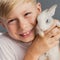 Little boy white Tshirt and tame dwarfish rabbit