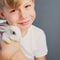 Little boy white Tshirt and tame dwarfish rabbit