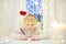 Little boy writing the letter to Santa. Child dreams of a gift that he can receive. Magic mail of Santa Claus. Traditions around