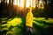 Little boy in a yellow jacket at sunset in the forest. Nature care concept.  Take care of the environment. Action against deforest