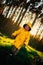 Little boy in a yellow jacket at sunset in the forest. Nature care concept.  Take care of the environment. Action against deforest