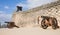 Little boy in yellow t-shirt climbing a cannon