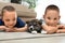 Little boys with Akita inu puppy on floor. Friendly dog