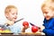 Little boys cutting apple with a kitchen knife