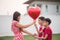 Little boys giving balloon heart to his mother love