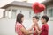 Little boys giving balloon heart to his mother love