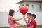 Little boys giving balloon heart to his mother love