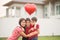 Little boys giving balloon heart to his mother love