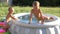 A little boys is playing in inflatable pools with water. Summer and holidays.
