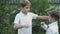 Little boys plays in rock-paper-scissors game outdoors