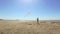 Little boys running and flying kites on beach