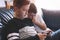 Little boys using smartphone on sofa