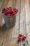 Little brass bucket of cherries on a table