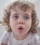 Little Brazilian girl making a smiling  face at camera