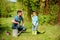 Little break. happy earth day. Family tree nursering. father and son in cowboy hat on ranch. watering can, pot and