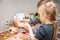 Little brother and sister baking cookies in the kitchen at home