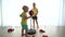 Little brother and sister hit punching bag. Active children siblings have fun