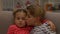 Little brother and sister hugging, boy kissing girl on cheek care, slow motion