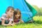 Little brother and sister lying inside tent