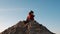 Little brother and sister sit on large sand pile and play